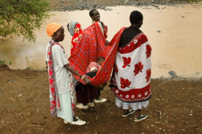 Family members taking a sick child to the dispensary